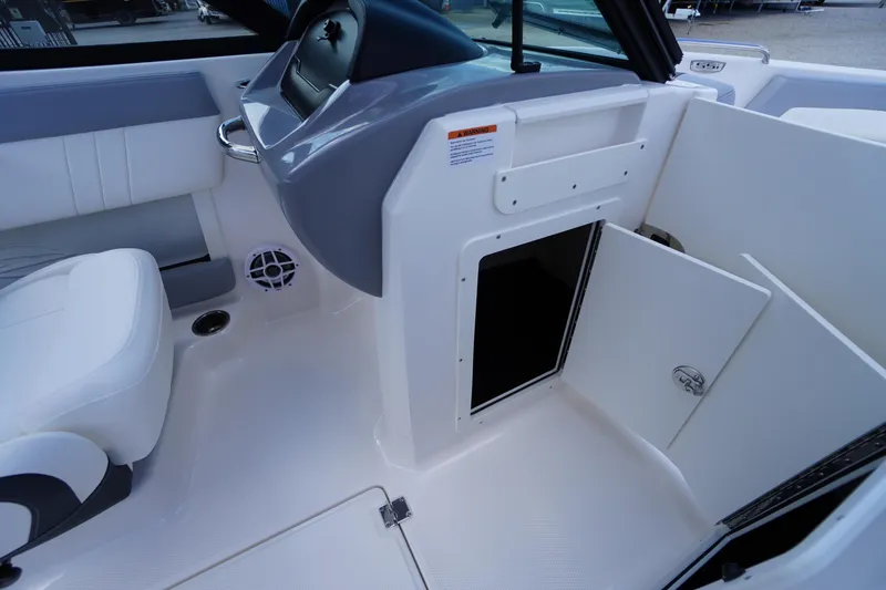 Slide: The Image of Interior view of 2026 Chaparral 21 SSi OB boat, featuring seating and storage compartment. - 23