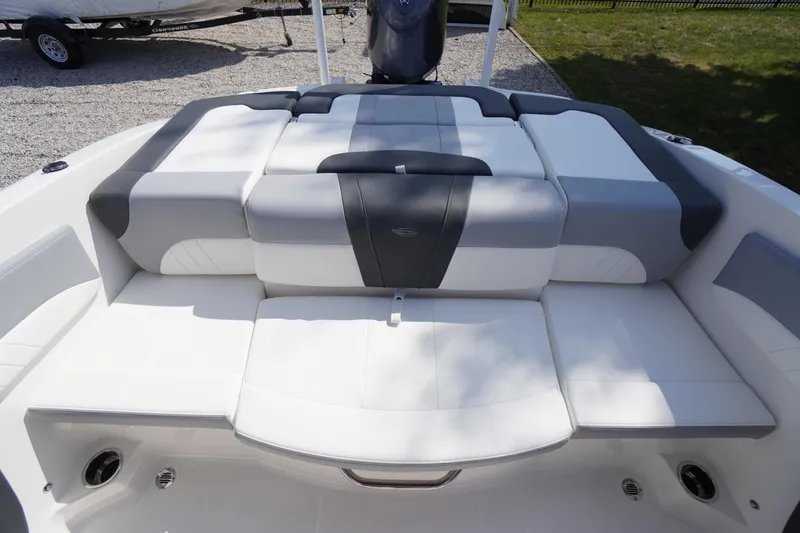 Slide: The Image of 2026 Chaparral 21 SSi OB boat interior with cushioned seating in white and gray. - 25