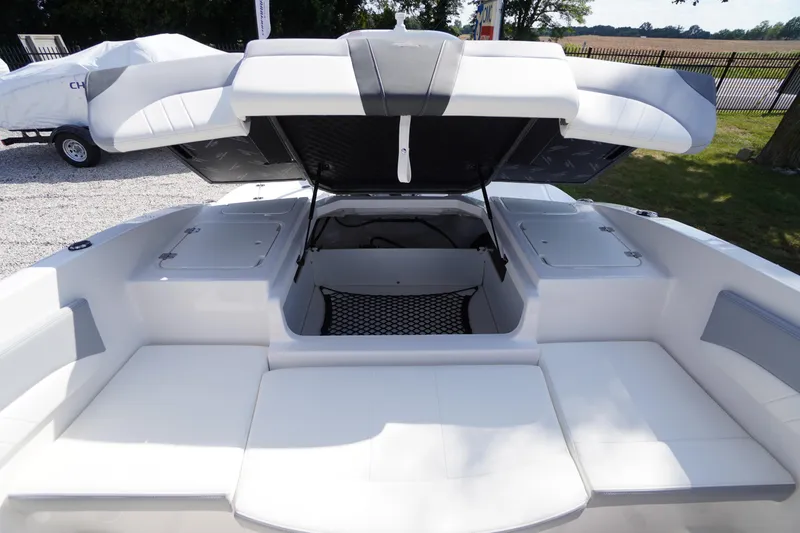 Slide: The Image of 2026 Chaparral 21 SSi OB boat interior with open storage compartments and seating. - 30