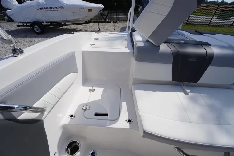 Slide: The Image of 2026 Chaparral 21 SSi OB boat interior with white seating and storage compartment. - 33