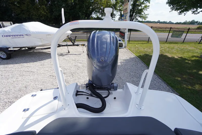 Slide: The Image of 2026 Chaparral 21 SSi OB boat with outboard motor, parked on gravel. - 36