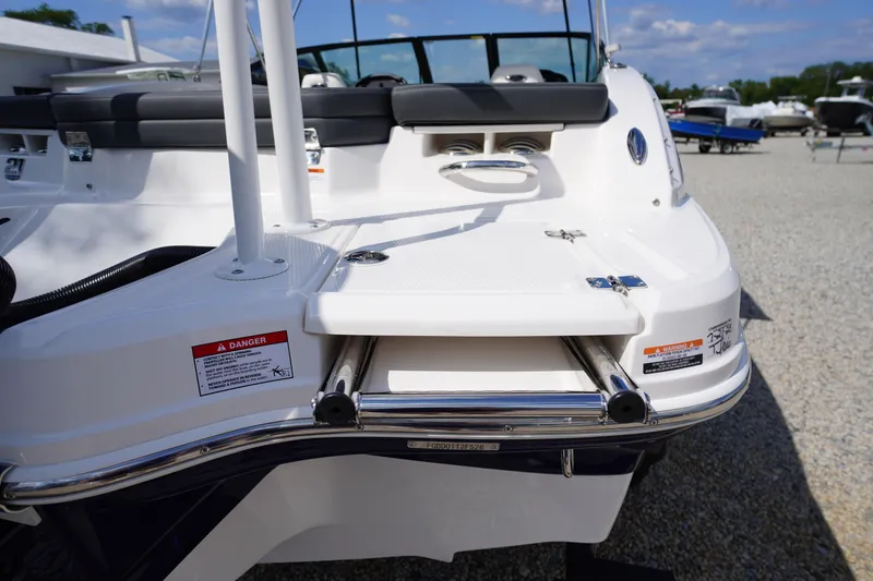 Slide: The Image of 2026 Chaparral 21 SSi OB boat with swim platform and ladder, displayed outdoors. - 38