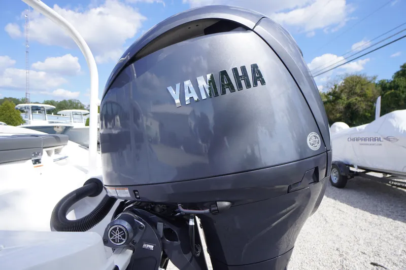 Slide: The Image of Yamaha outboard motor on 2026 Chaparral 21 SSi OB boat, sunny day, outdoor setting. - 41