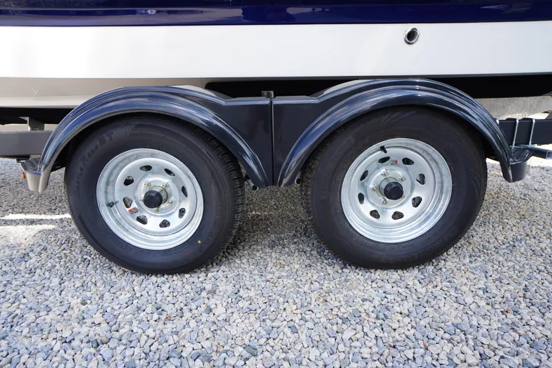 Slide: The Image of Trailer wheels of 2026 Chaparral 21 SSi OB boat on gravel surface. - 44