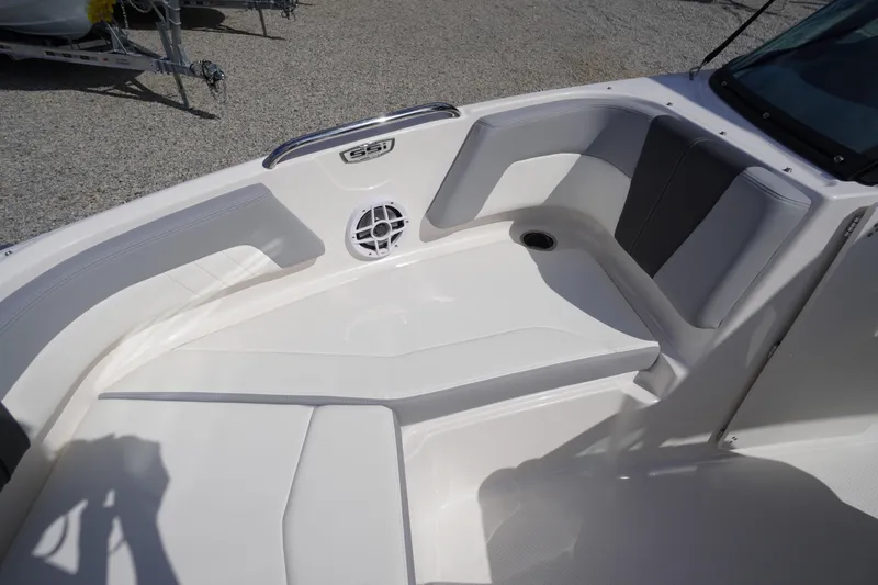Slide: The Image of Interior seating of 2026 Chaparral 21 SSi OB boat, featuring sleek white and gray design. - 7