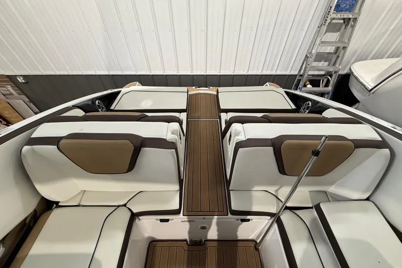 Slide: The Image of 2023 Yamaha Boats 252SD interior with white and brown seating, wooden flooring. - 11