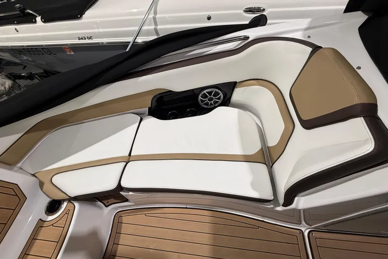 Slide: The Image of 2023 Yamaha Boats 252SD interior with tan and white seating, featuring a built-in speaker. - 13
