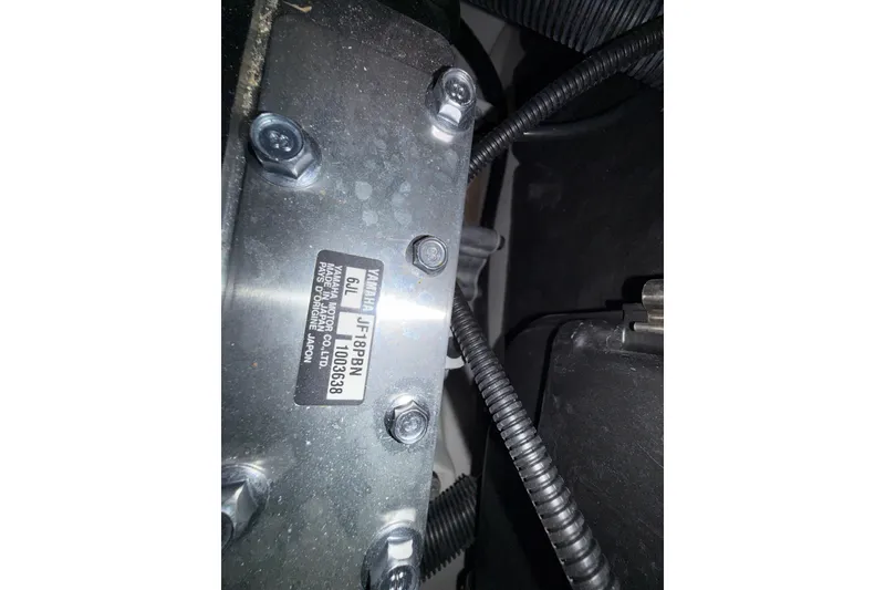 Slide: The Image of Close-up of Yamaha Boats 252SD 2023 engine component with label and bolts. - 17