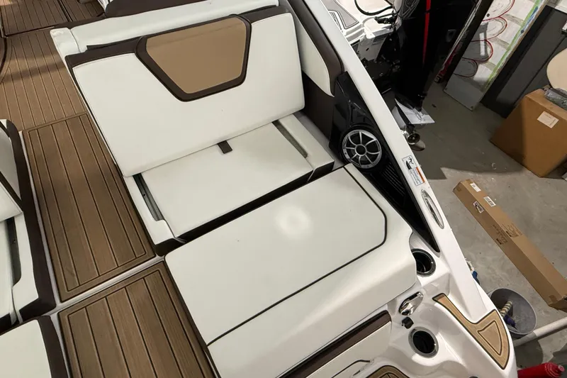 Slide: The Image of 2023 Yamaha Boats 252SD interior with white seating and wood-style flooring. - 19