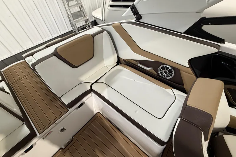 Slide: The Image of 2023 Yamaha Boats 252SD interior with white and brown seating, showcasing modern design. - 21