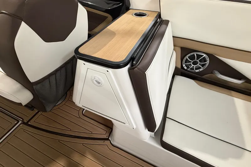 Slide: The Image of 2023 Yamaha Boats 252SD interior with seating, speaker, and cup holder. - 23