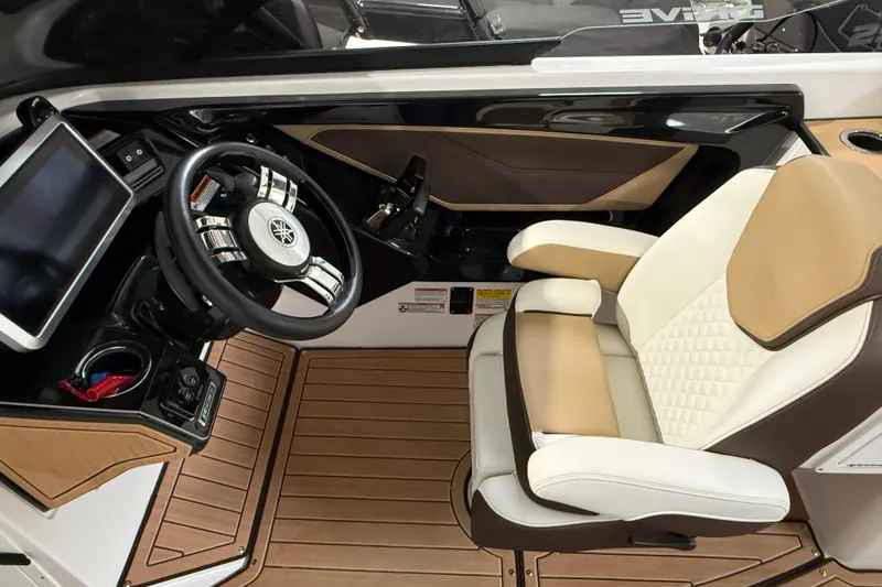 Slide: The Image of 2023 Yamaha Boats 252SD cockpit with steering wheel and luxurious seating. - 28