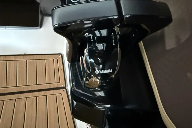 Slide: The Image of Close-up of 2023 Yamaha Boats 252SD throttle control on deck. - 29