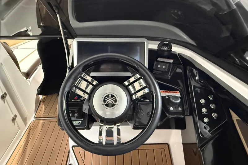 Slide: The Image of 2023 Yamaha Boats 252SD steering wheel and dashboard, featuring modern controls and sleek design. - 30