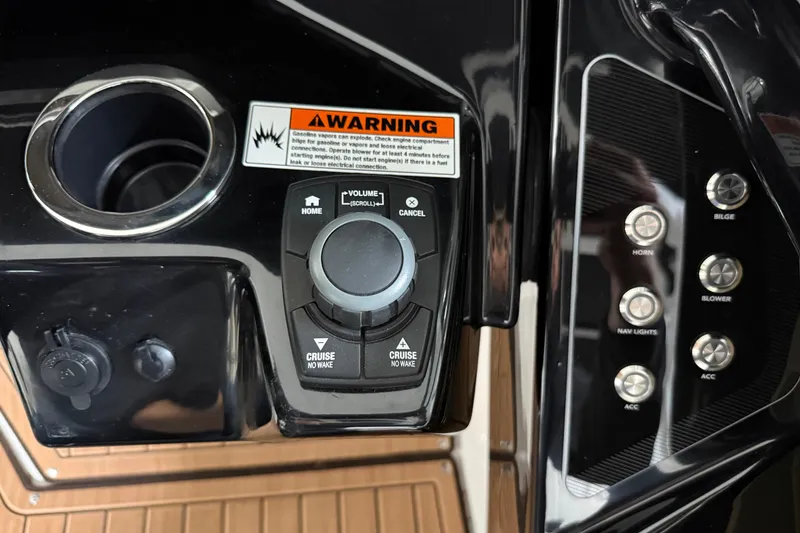 Slide: The Image of Control panel of 2023 Yamaha Boats 252SD with warning label and buttons. - 32