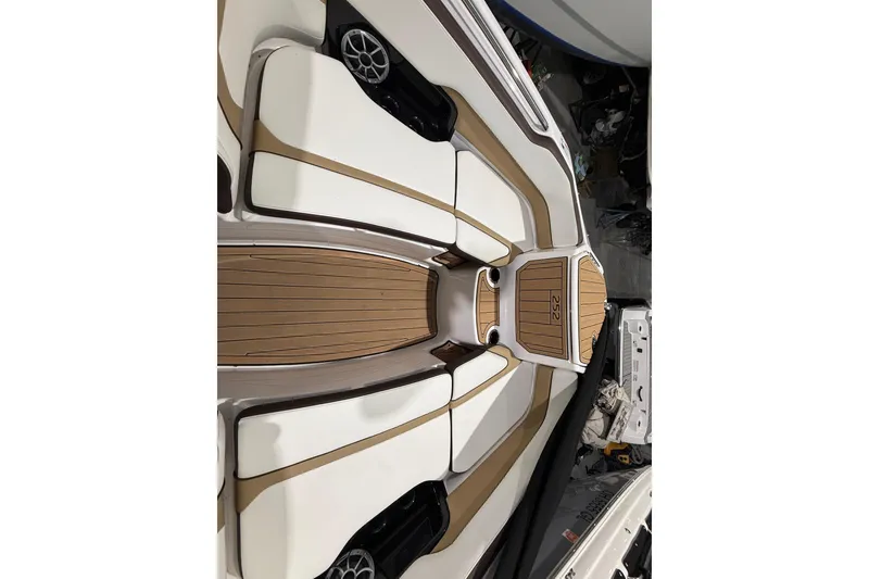 Slide: The Image of 2023 Yamaha Boats 252SD interior with sleek seating and wood accents. - 35