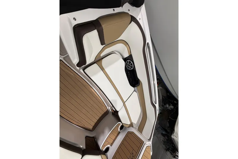 Slide: The Image of 2023 Yamaha Boats 252SD interior with tan and white seating, featuring a speaker. - 36