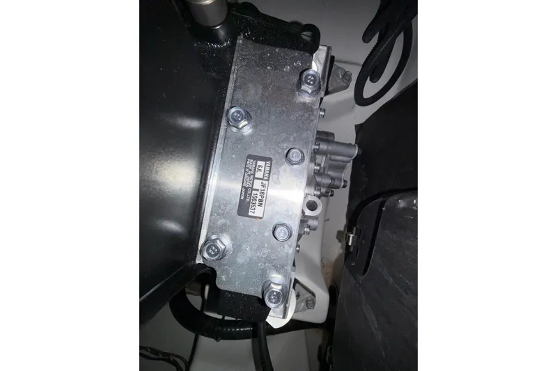 Slide: The Image of Engine component of 2023 Yamaha Boats 252SD, showcasing metal parts and serial number. - 37