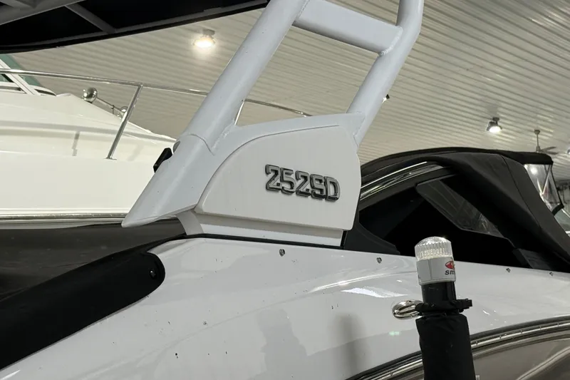 Slide: The Image of 2023 Yamaha Boats 252SD, sleek design detail in a well-lit showroom. - 7