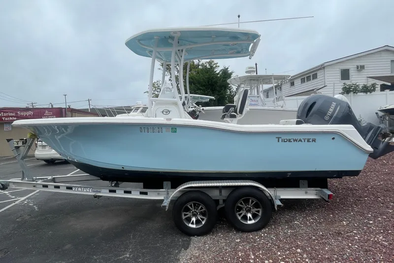 The Image of 2021 Tidewater 210 CC Adventure boat on trailer, light blue hull, Yamaha engine. - 0