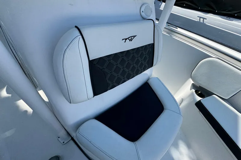 Slide: The Image of 2021 Tidewater 210 CC Adventure boat seat with black and white upholstery. - 12
