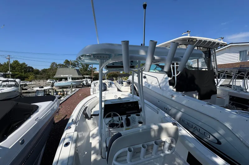 Slide: The Image of 2021 Tidewater 210 CC Adventure boat docked among other vessels under clear blue sky. - 18