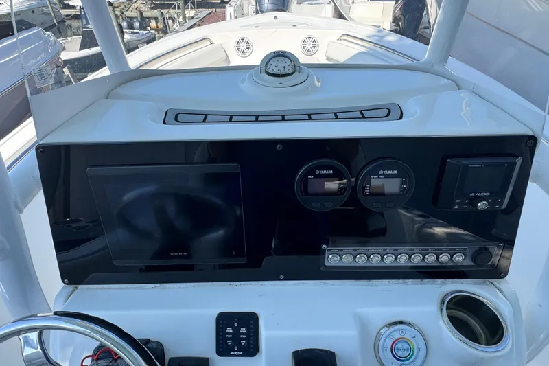 Slide: The Image of 2021 Tidewater 210 CC Adventure boat dashboard with Garmin display and Yamaha gauges. - 2