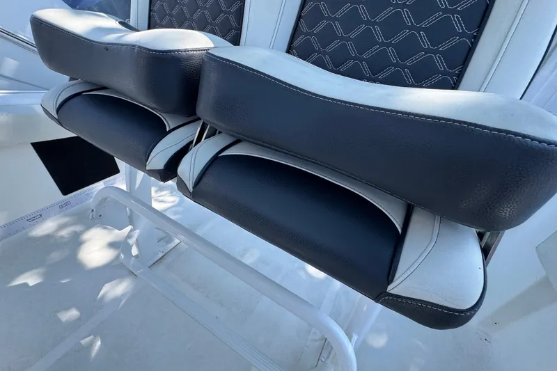 Slide: The Image of 2021 Tidewater 210 CC Adventure boat seating with black and white cushioned design. - 21
