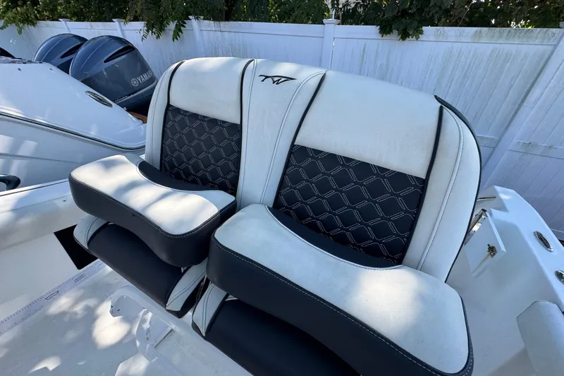 Slide: The Image of 2021 Tidewater 210 CC Adventure boat seats with stylish black and white design. - 22