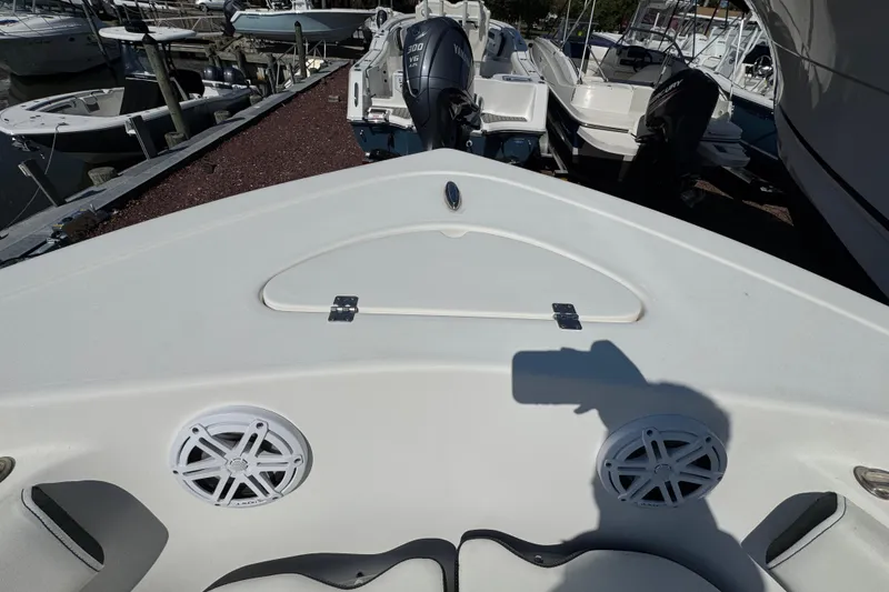 Slide: The Image of 2021 Tidewater 210 CC Adventure boat interior with speakers and storage compartment. - 24