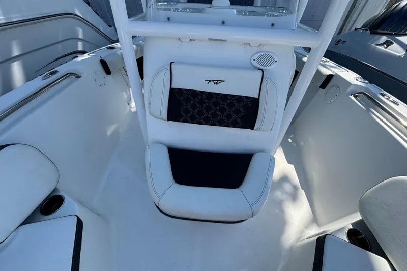 Slide: The Image of 2021 Tidewater 210 CC Adventure boat interior with white and black seating. - 25