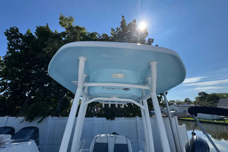Slide: The Image of 2021 Tidewater 210 CC Adventure boat with T-top under clear blue sky. - 26