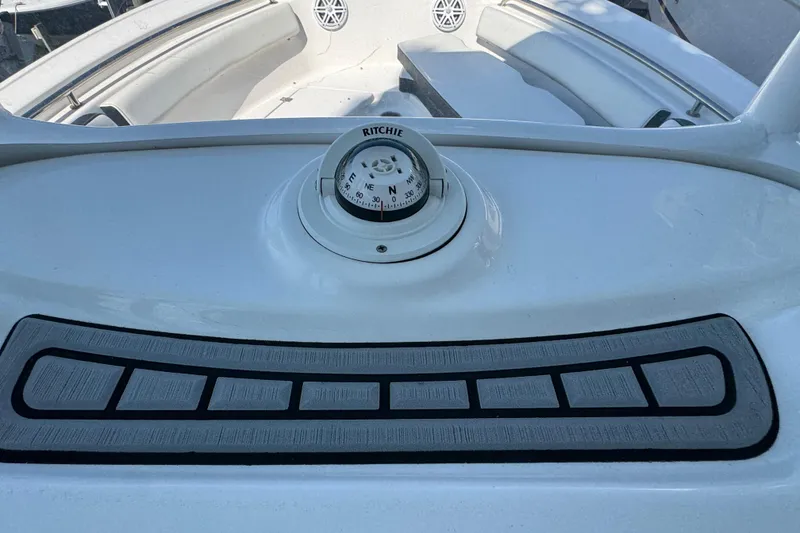 Slide: The Image of 2021 Tidewater 210 CC Adventure boat dashboard with compass and seating area. - 3