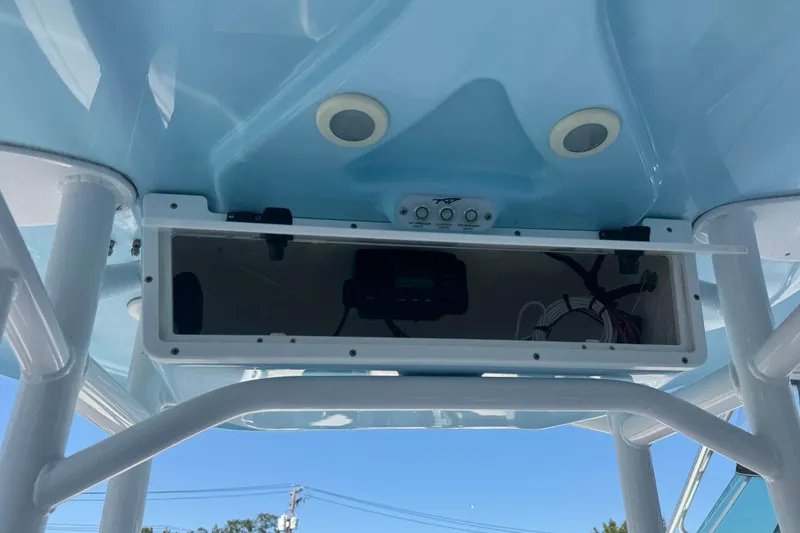 Slide: The Image of 2021 Tidewater 210 CC Adventure boat console with storage compartment and controls. - 7