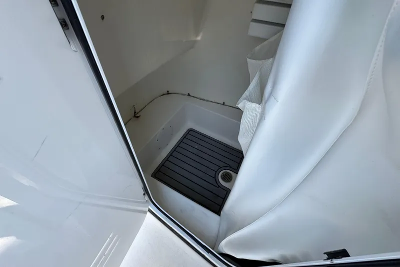 Slide: The Image of Interior view of 2021 Tidewater 210 CC Adventure boat's cabin with shower area. - 9