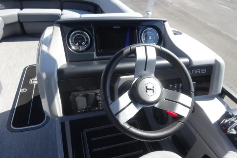 Slide: The Image of 2026 Harris Solstice 250 boat dashboard with steering wheel and modern controls. - 14