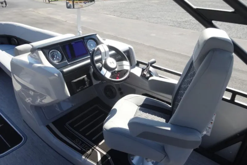 Slide: The Image of Interior of 2026 Harris Solstice 250 boat, featuring modern steering and dashboard. - 6