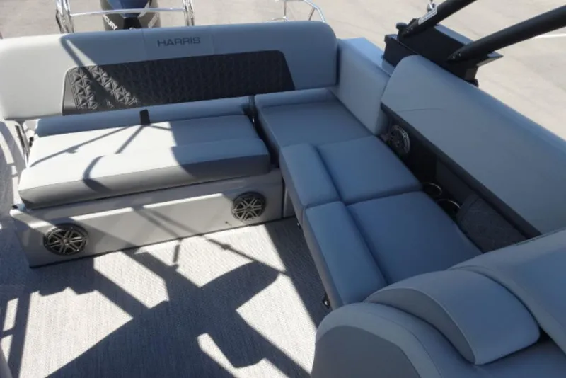Slide: The Image of 2026 Harris Solstice 250 boat interior with gray seating and built-in speakers. - 7