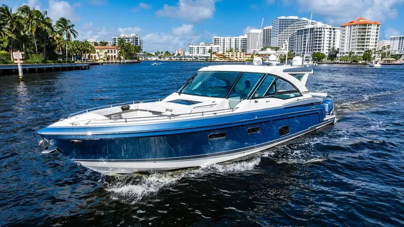 Slide: The Image of 2019 Formula 430 All Sport Crossover yacht cruising in a scenic waterfront cityscape. - 17