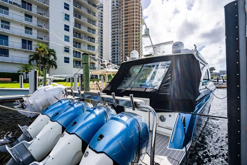 Slide: The Image of 2019 Formula 430 All Sport Crossover boat docked with multiple outboard engines. - 26