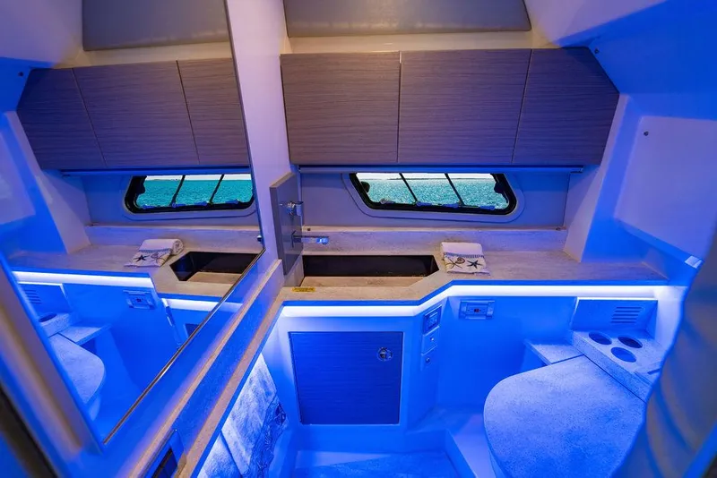 Slide: The Image of 2019 Formula 430 All Sport Crossover interior with modern cabinetry and ambient blue lighting. - 45