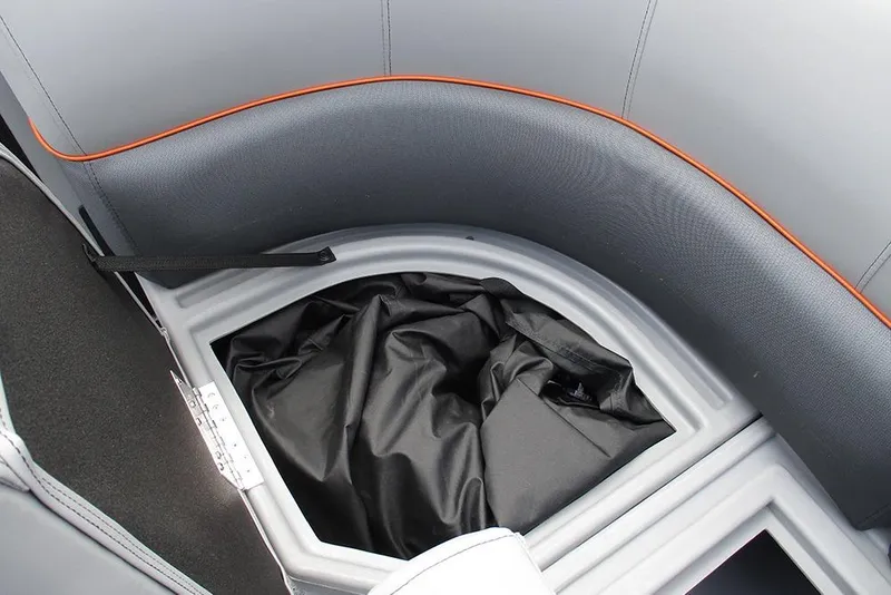 Slide: The Image of 2026 Bentley Pontoons 223 Bolt interior storage compartment with sleek design and black fabric. - 18