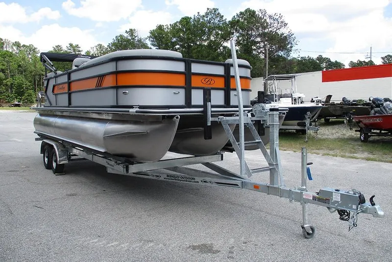 Slide: The Image of 2026 Bentley Pontoons 223 Bolt on trailer, parked outdoors, showcasing sleek design and vibrant colors. - 5