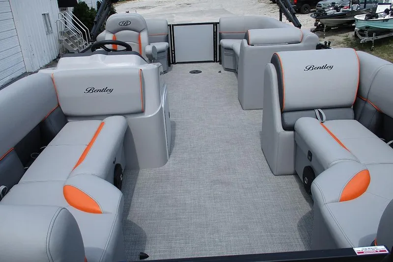 Slide: The Image of 2026 Bentley Pontoons 223 Bolt interior with gray and orange seating. - 9