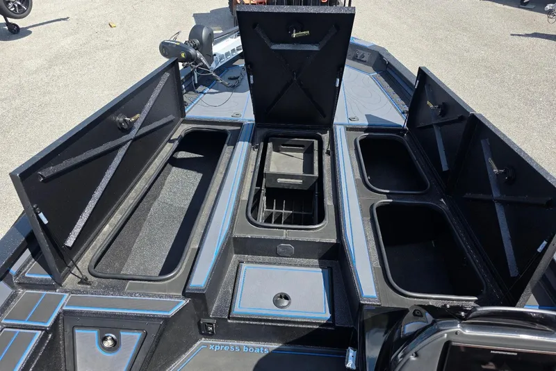 Slide: The Image of Open storage compartments on a 2026 Xpress X21 Pro boat deck. - 11