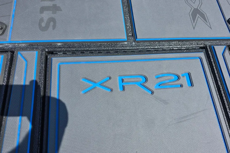 Slide: The Image of Xpress X21 Pro 2026 floor mat with blue accents and XR21 branding. - 13