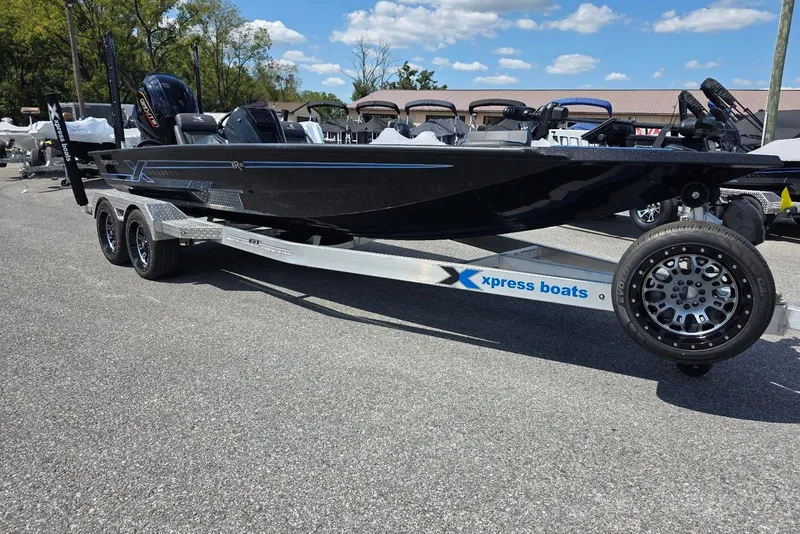 Slide: The Image of 2026 Xpress X21 Pro boat on trailer under clear blue sky. - 2