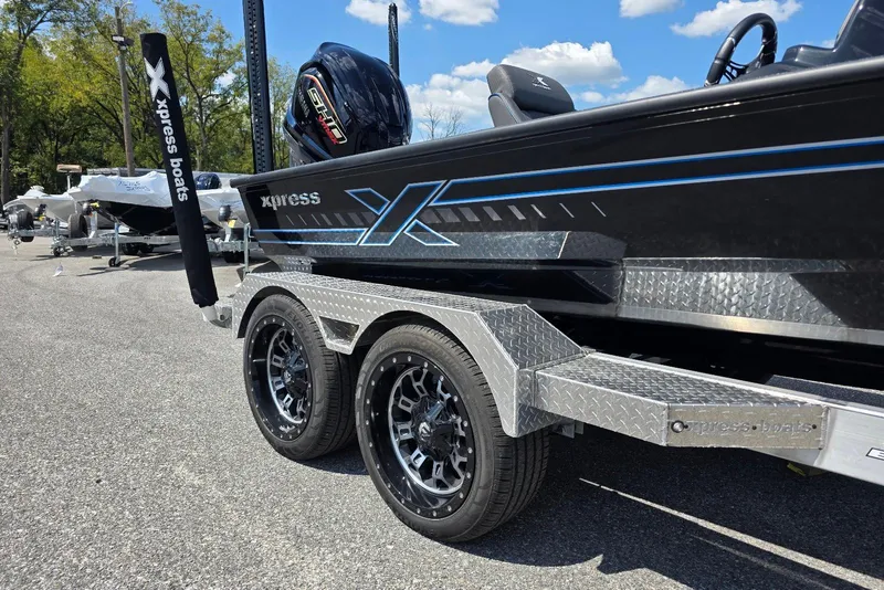 Slide: The Image of 2026 Xpress X21 Pro boat on trailer, featuring sleek design and modern wheels. - 4