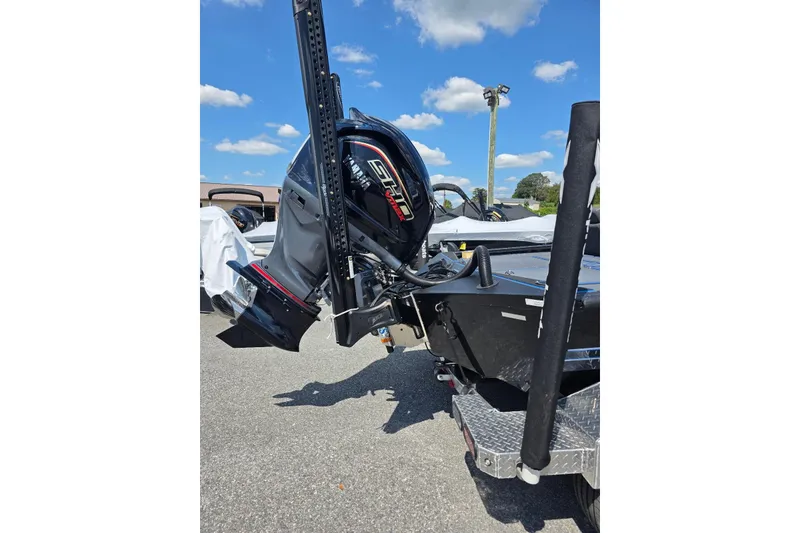 Slide: The Image of 2026 Xpress X21 Pro boat with powerful outboard motor, parked under a clear blue sky. - 6