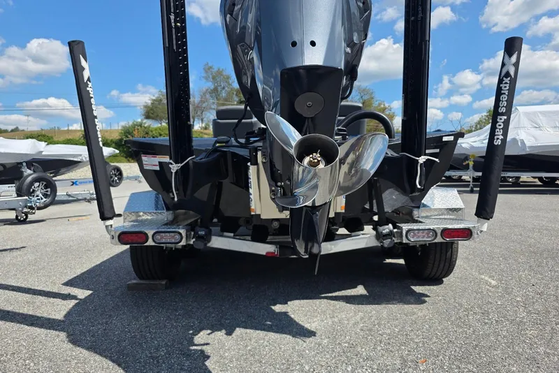 Slide: The Image of Rear view of 2026 Xpress X21 Pro boat on trailer, showcasing propeller and motor. - 7